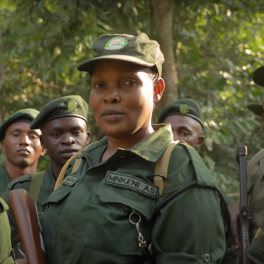 A group of uniformed wildlife rangers pose for a photo.