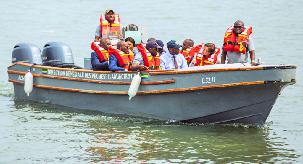 The patrol boat Albacore carries several people in bright orange life jackets.