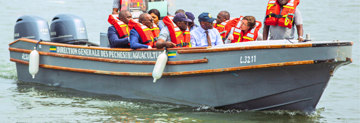 The patrol boat Albacore carries several people in bright orange life jackets.