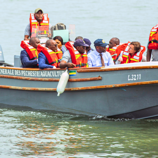 The patrol boat Albacore carries several people in bright orange life jackets.